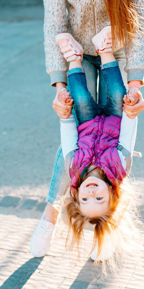 Mom and girl playing, having fun